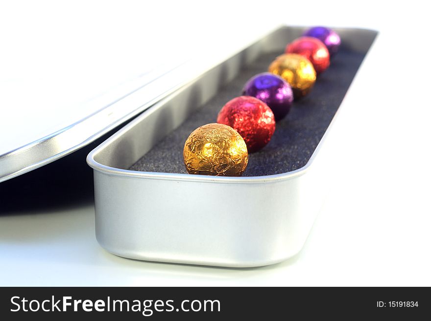 Chocolate balls in luxury package with white background