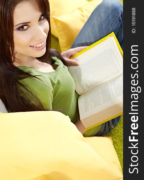 Woman at home reading a book, spring concept