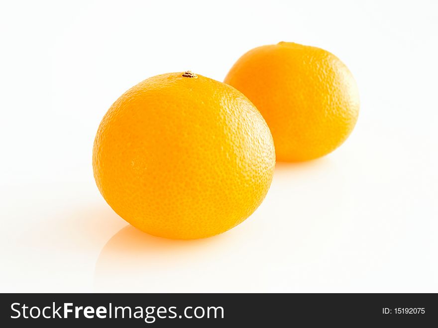 Two ripe tangerines, close-up, on white background. Two ripe tangerines, close-up, on white background.