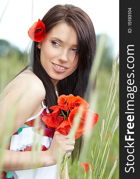 Summer girl running in poppy field