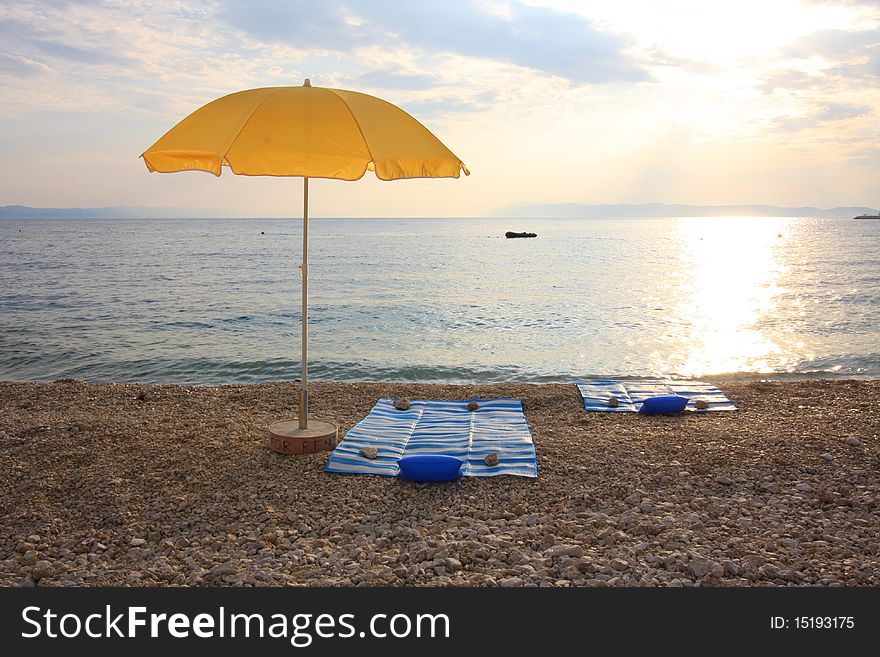Yellow beach umbrella - landscape in Croatia