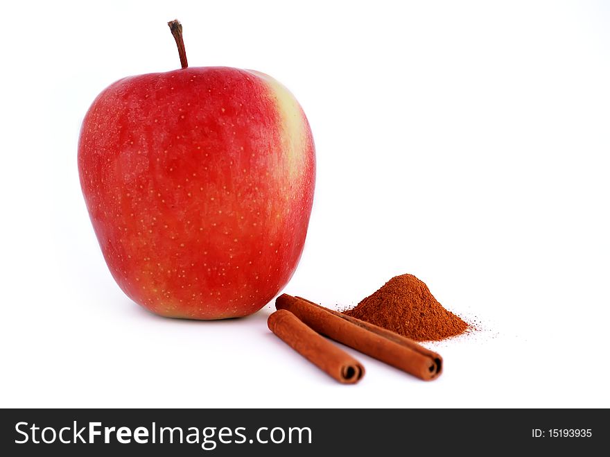 Red apple with cinnamon on a white background. Red apple with cinnamon on a white background