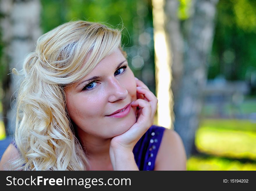 Beautiful young woman with hairstyle outdoors