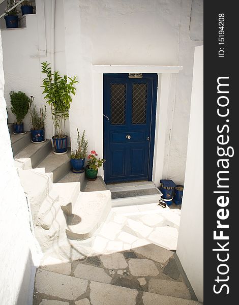 Traditional Greek village of whitewashed houses with blue doors in a greek island