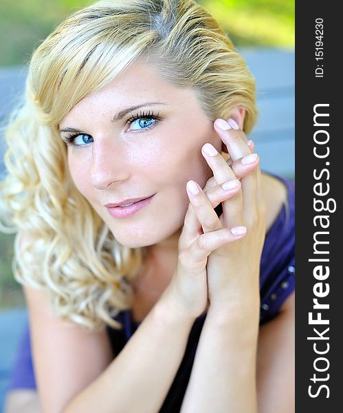 Beautiful young woman with fashion hairstyle outdoors in summer park. blurred background. Beautiful young woman with fashion hairstyle outdoors in summer park. blurred background