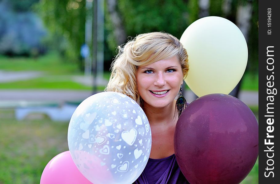 Beautiful woman with baloons outdoors