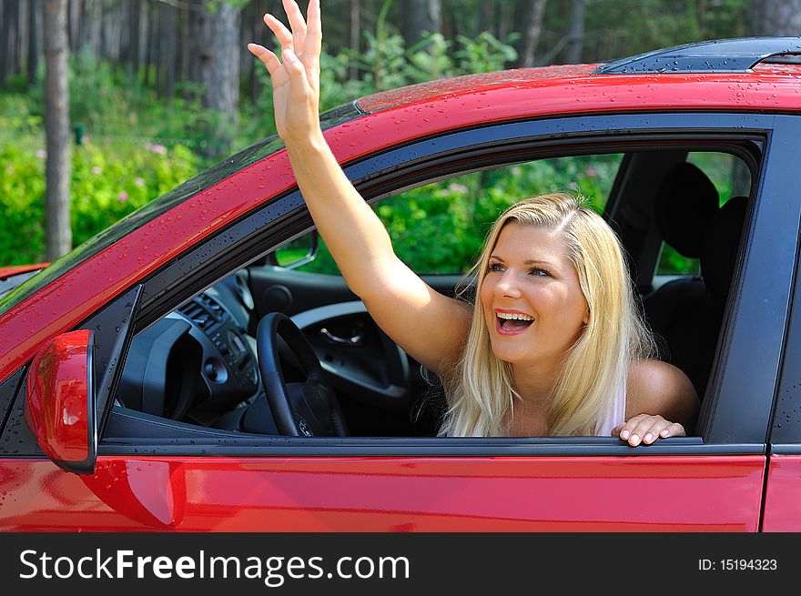 Beautiful Woman Driver In Red Shiny Car Outdoors