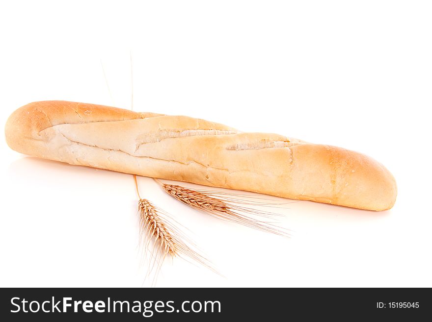 Wheat and a baked baguette isolated over a white background