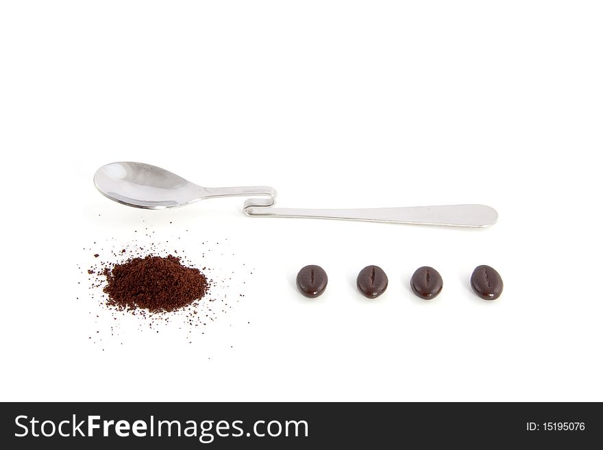 Spoon with filter coffee and beans isolated over white