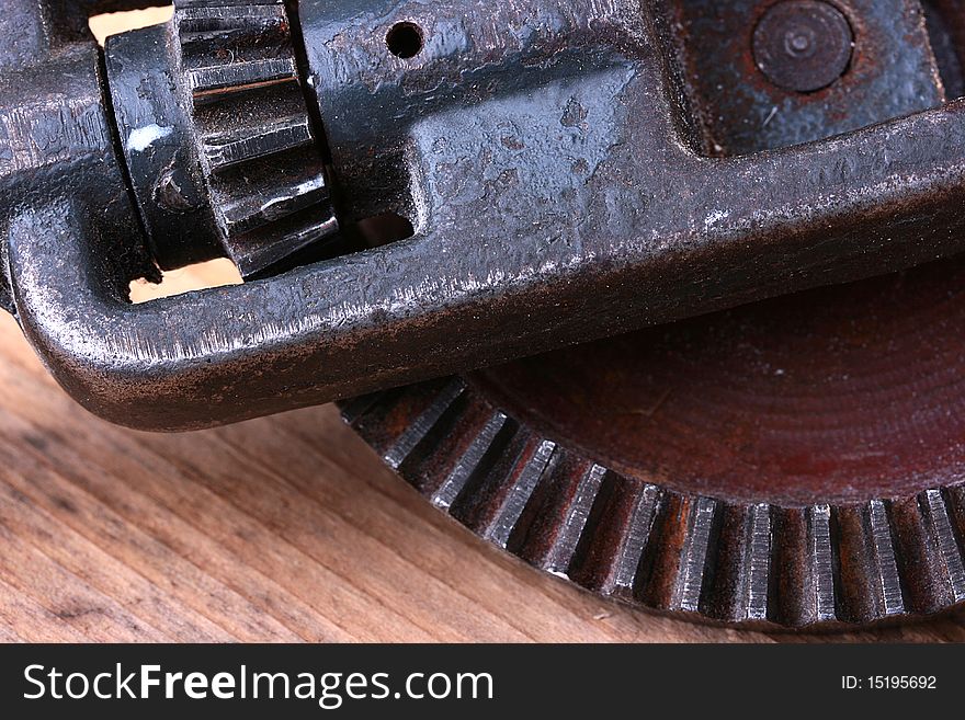 Old steel gear wheel on a wooden table. Old steel gear wheel on a wooden table.