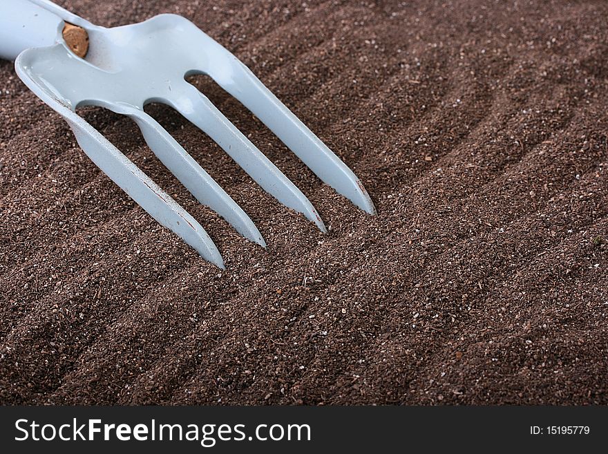 Metal rake for work on a personal plot.