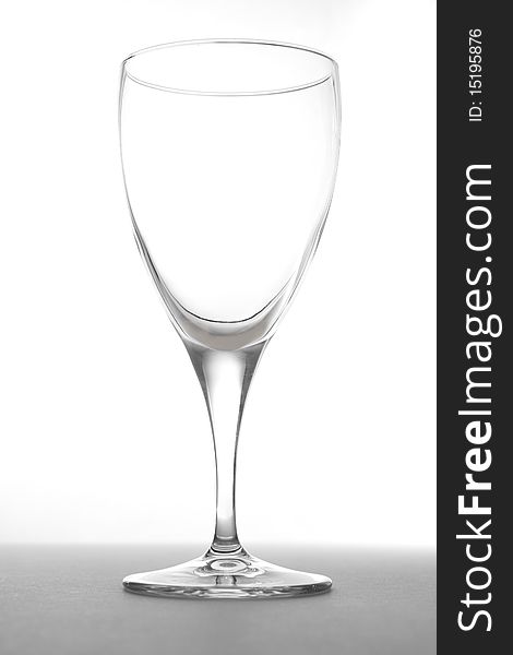 A simple studio shot of an empty wine glass on a white background.