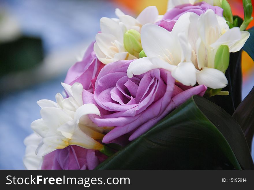 A bridal bouquet of lila and white roses.