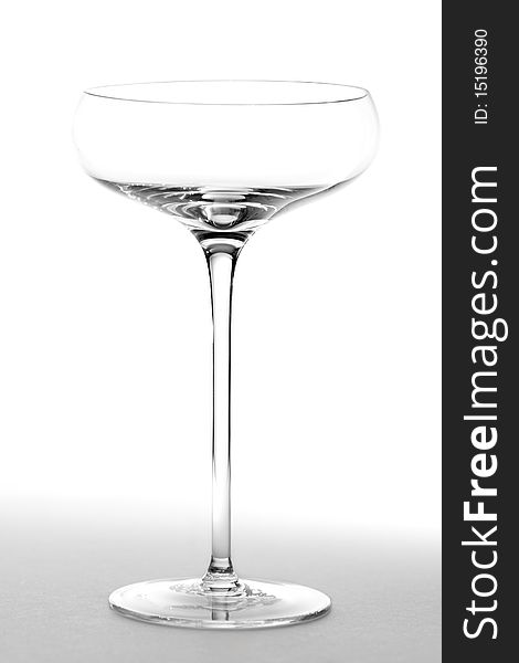 An empty saucer style champage glass.  Studio isolated on a white background. An empty saucer style champage glass.  Studio isolated on a white background.