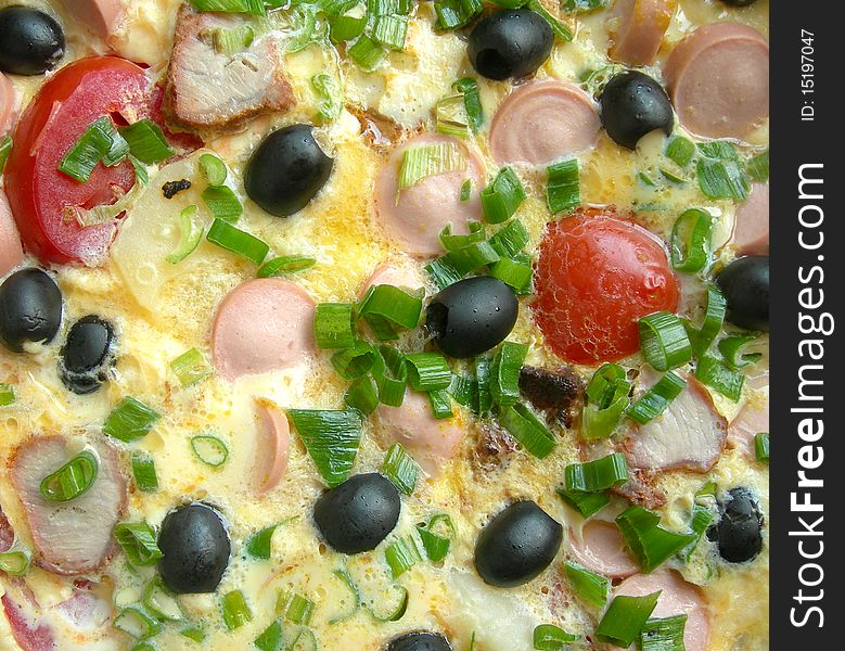 Omelet with sausages and vegetables is shown in the picture. Omelet with sausages and vegetables is shown in the picture.