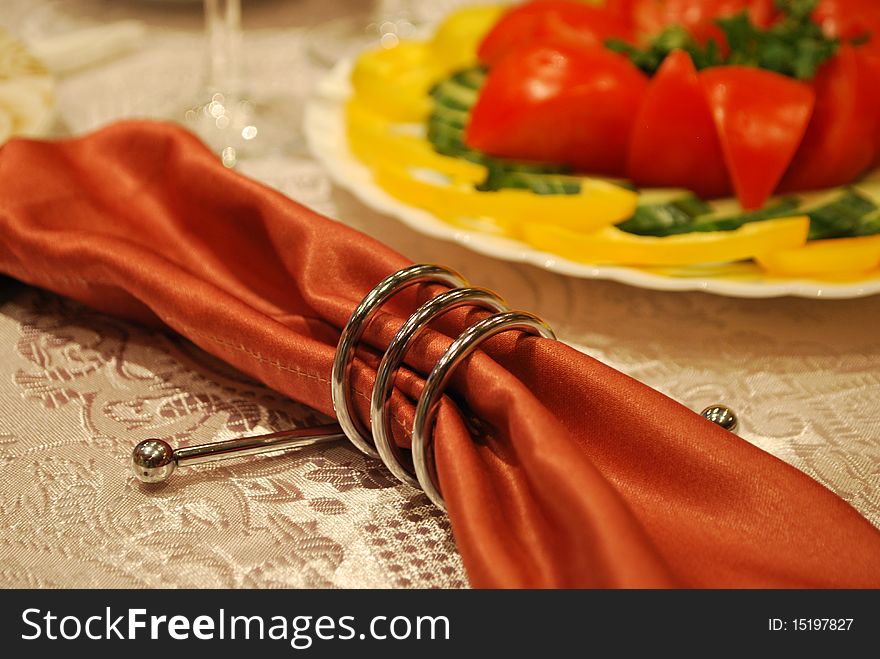 Napkin holder on a table with vegetables