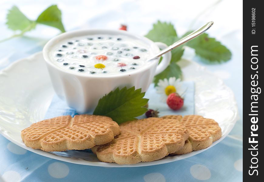 Glass of milk with cookies and berries for breakfast. Glass of milk with cookies and berries for breakfast