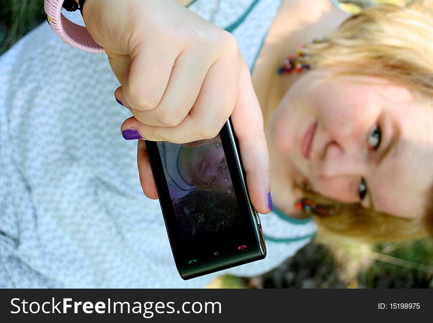 Young woman taking a self picture.