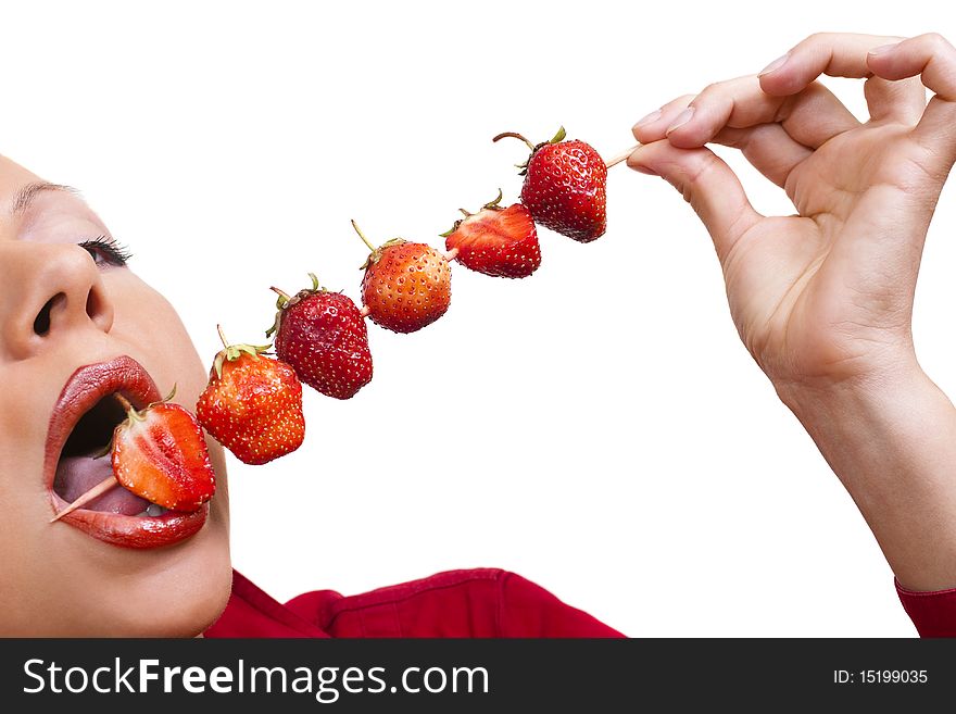 Woman`s mouth  with red strawberries sticked on skewer isolated on white background