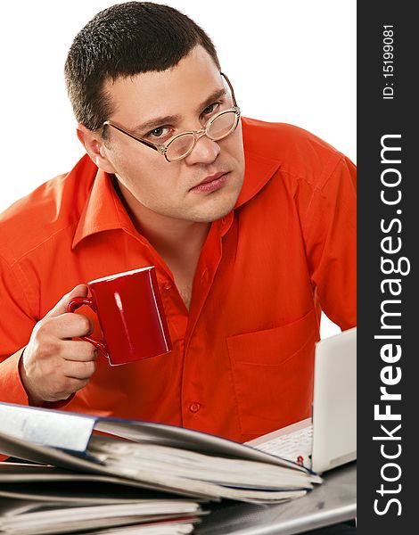 Funny businessman surrounded by files drinking coffe