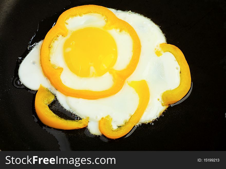 Fried eggs with yellow pepper.