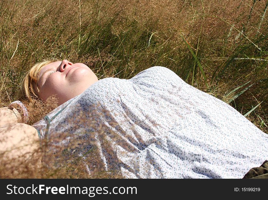 Relaxing woman laying on grass