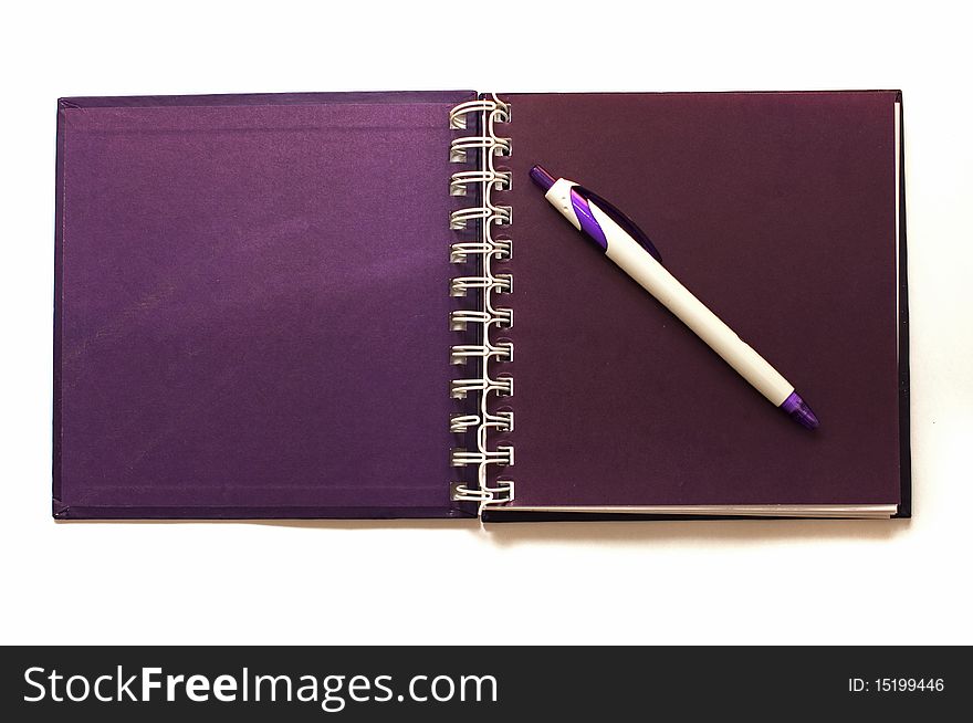 An open spiral notebook and ball pen. An open spiral notebook and ball pen