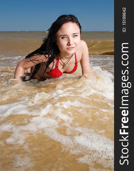 Pretty girl in water splashes at the seaside. Pretty girl in water splashes at the seaside