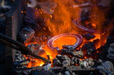 Blacksmith Furnace With Burning Coals, Tools, And Glowing Hot Horseshoe Stock Image