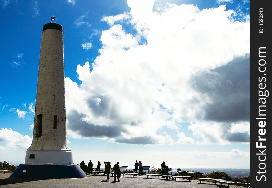 Tourists near a tower at the lookout viewing the City. Tourists near a tower at the lookout viewing the City