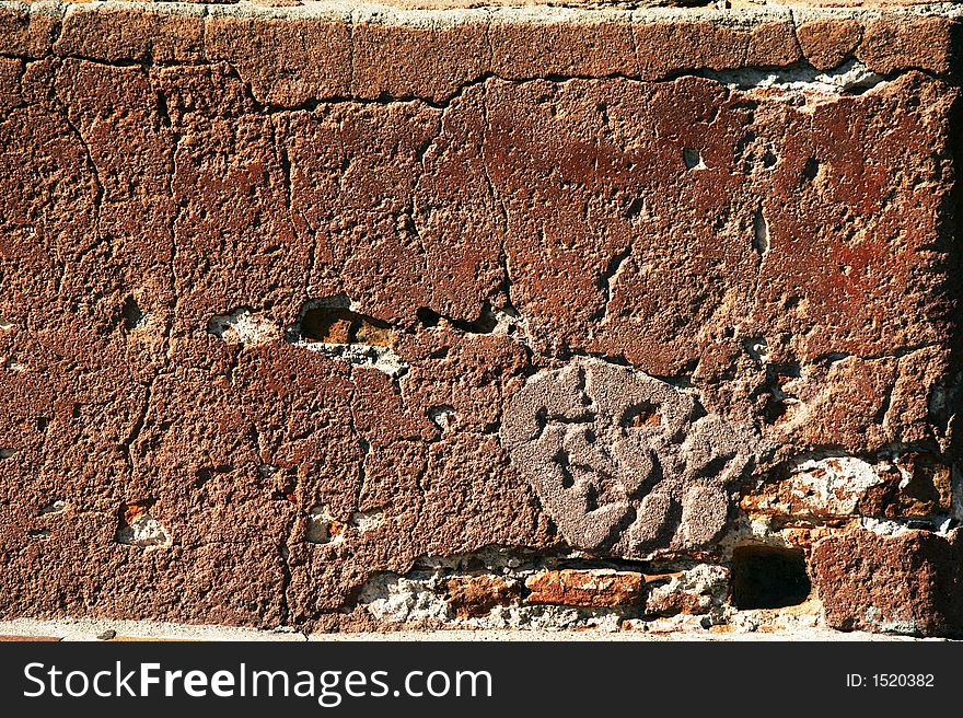 Red brick wall in sunshine - landscape format