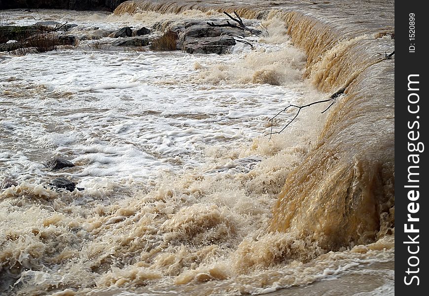 Autumn waterfall in a river, view