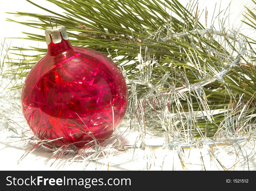 Christmas ball and tinsel over white