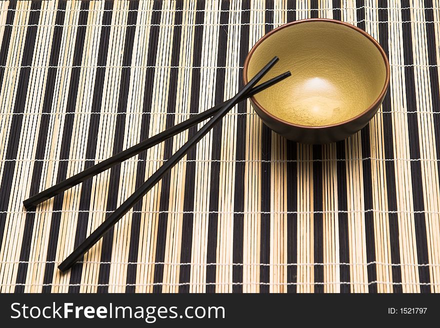 Chopsticks with small pan on matting