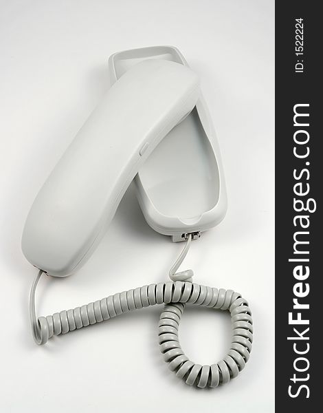 White phone with wire and buttons
