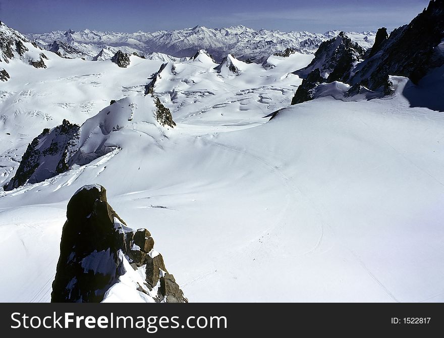 From Aiguille du Midi peak, 3800m high, view of white valley in massif of Mont Blanc, Alps, France. From Aiguille du Midi peak, 3800m high, view of white valley in massif of Mont Blanc, Alps, France