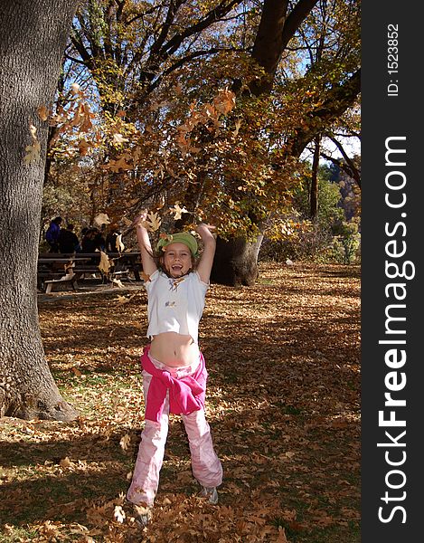 Girl Tossing Leaves