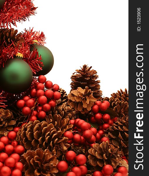 A shiny red Christmas tree decorated with ornaments, pine cones and berries. A shiny red Christmas tree decorated with ornaments, pine cones and berries