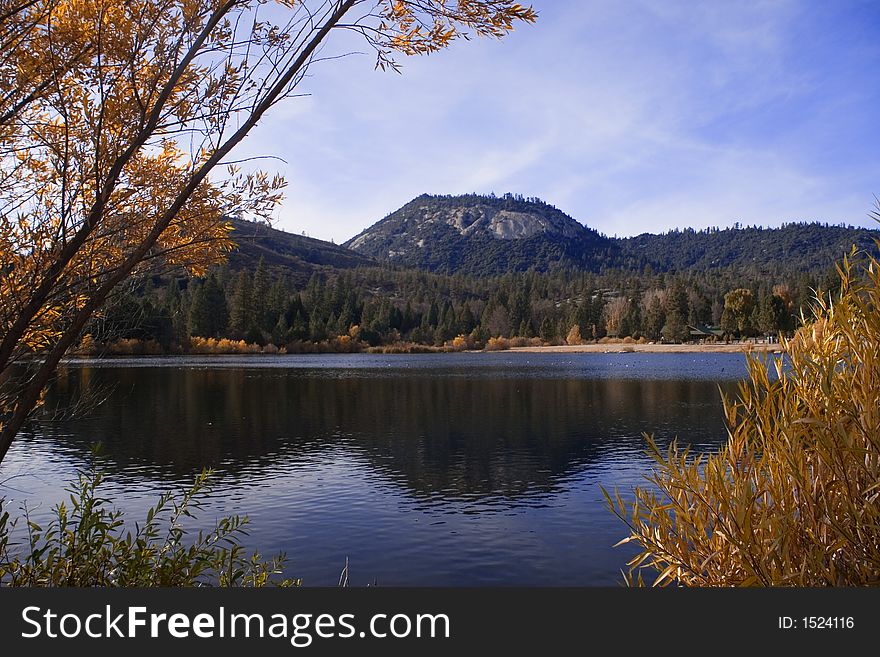 Fall colors and blue skies reflected in lake. Fall colors and blue skies reflected in lake