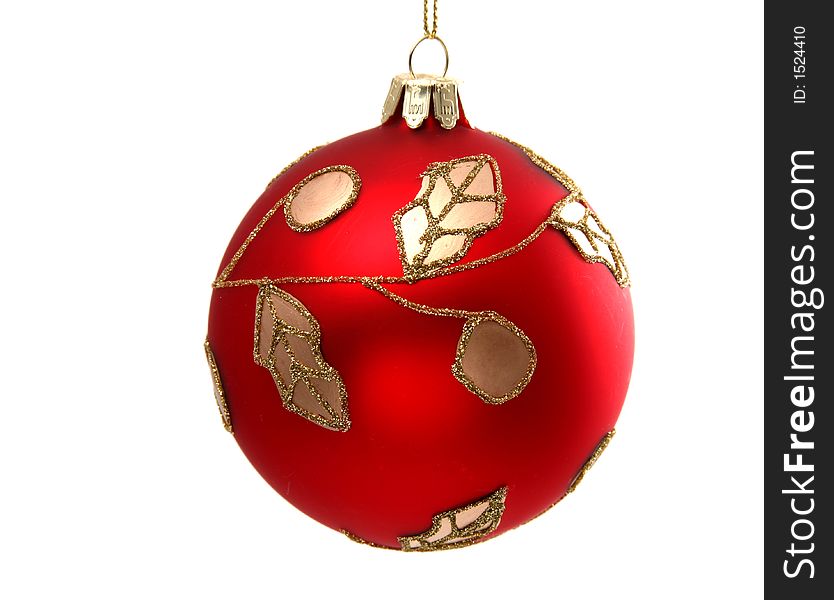 Red ball with golden ornamentation on a white background. Red ball with golden ornamentation on a white background.
