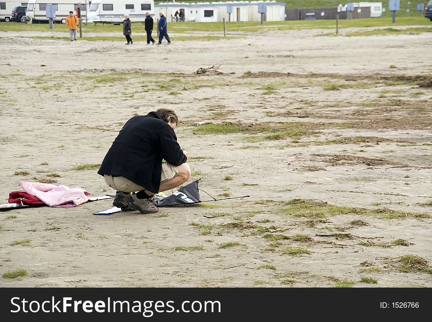 This picture shows a man by the beach during start preparation for a kite. Summer 2006. This picture shows a man by the beach during start preparation for a kite. Summer 2006
