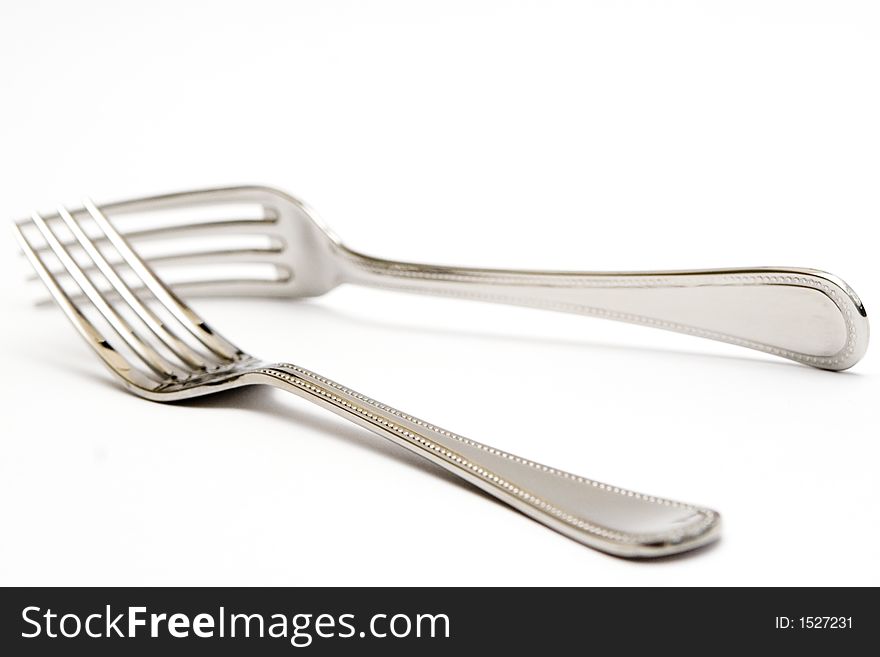 Pair of silver forks set on a white background - isolated