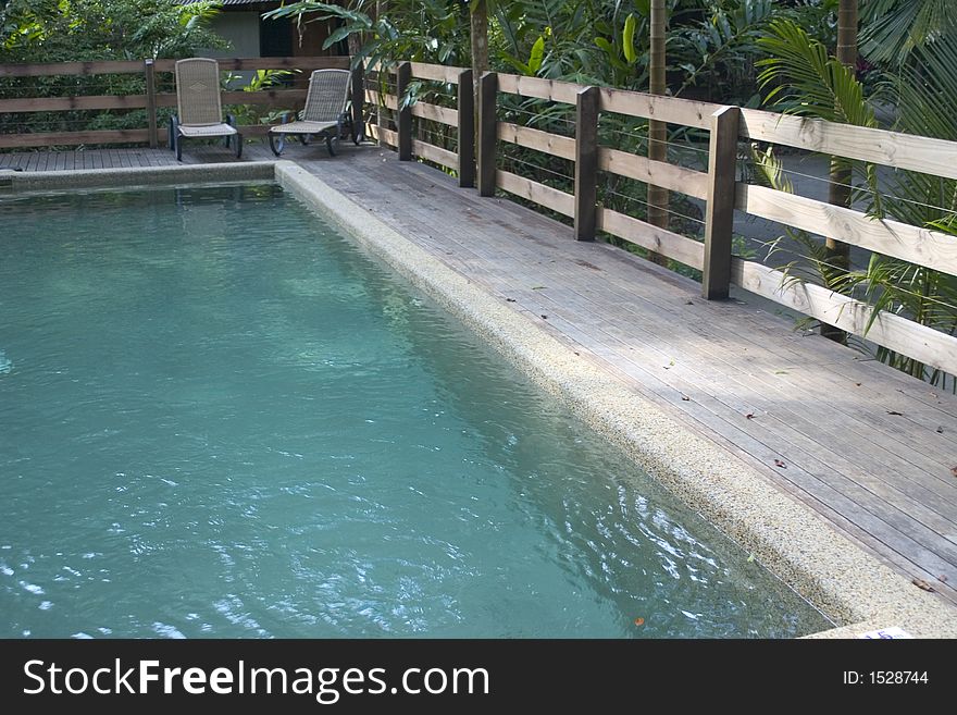 Outdoor pool in jungle with decking