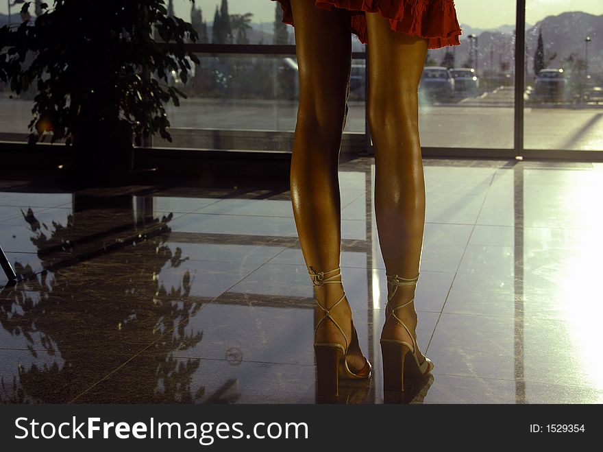 Woman legs at the airport