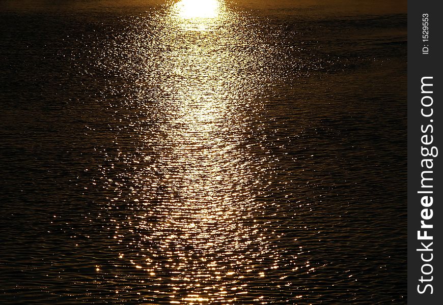 The path of the sun on a river in Mapouto, Mozambique. The path of the sun on a river in Mapouto, Mozambique