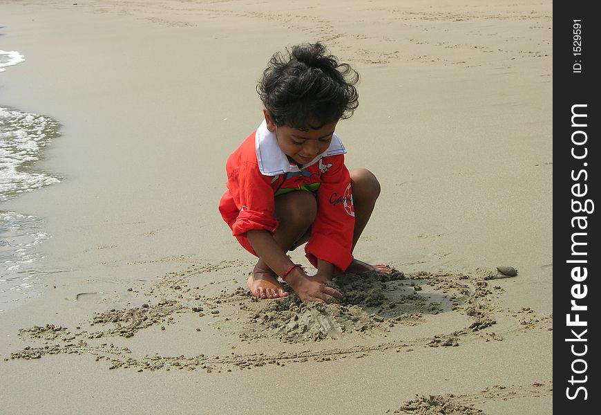 An image showing a child playing on a beach. An image showing a child playing on a beach