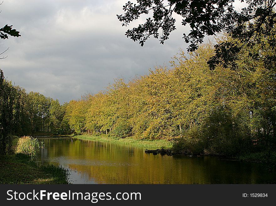 The threes along the canal around the House of Voorstonden, a neighbourhood in the surroundings of Zutphen (the Netherlands), are colouring in autumn. The threes along the canal around the House of Voorstonden, a neighbourhood in the surroundings of Zutphen (the Netherlands), are colouring in autumn.