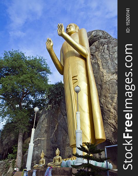 Buddha stands Wat KhaoTakiab , near Huahin beach , Thailand , (at take a photograph from the side)