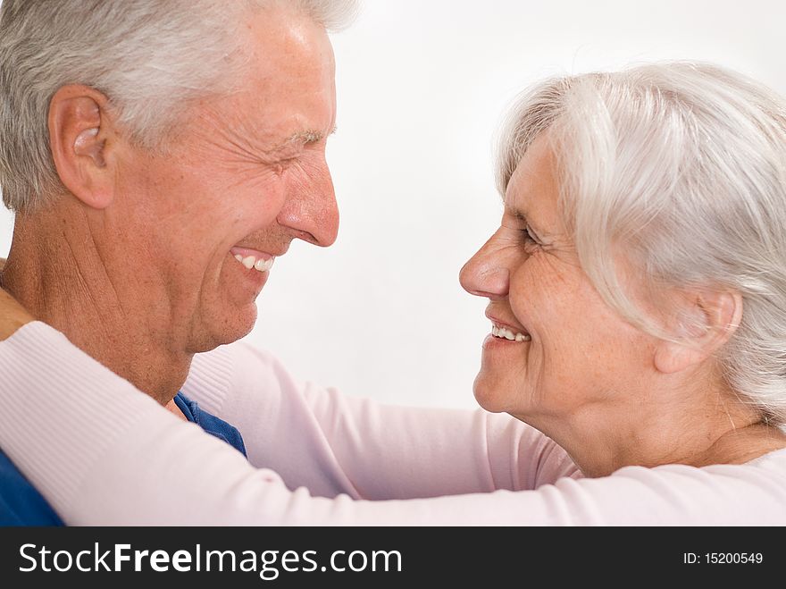 Happy elderly couple together on a white background