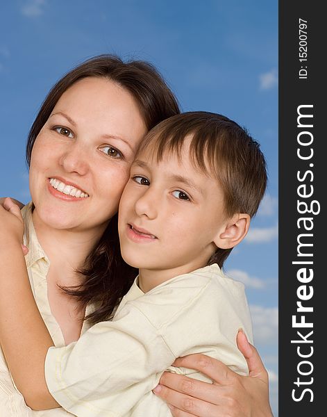 Woman woman  with  son on a background of sky. Woman woman  with  son on a background of sky